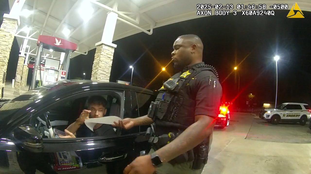Body camera frame showing Martin County deputy speaking to a driver at a gas station